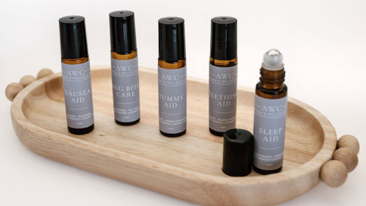 Set of AWC roller bottles on a wooden tray with a white background